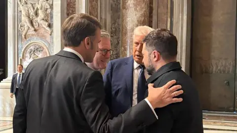 Andriy Yermak/Telegram UK Prime Minister Sir Keir Starmer and French President Emmanuel Macron speak with Trump and Zelensky in St Peter