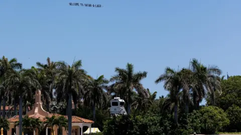 Reuters A plane flying a flat above Mar-a-Lago displaying writing reading